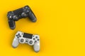 Computer game competition. Gaming concept. White and black joystick isolated on yellow background Royalty Free Stock Photo