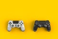 Computer game competition. Gaming concept. White and black joystick isolated on yellow background Royalty Free Stock Photo