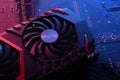 Computer game graphics card, videocard with two coolers on circuit board ,motherboard background. Close-up. With red-blue lighting Royalty Free Stock Photo