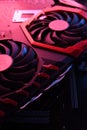 Computer game graphics card, videocard with two coolers on circuit board ,motherboard background. Close-up. With red-blue lighting Royalty Free Stock Photo