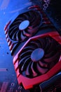 Computer game graphics card, videocard with two coolers on circuit board ,motherboard background. Close-up. With red-blue lighting Royalty Free Stock Photo