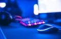 Computer gamer workplace for new game mouse and keyboard with blur pink neon light background Royalty Free Stock Photo