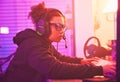 Computer games, young girl and headset in home for esports, online rpg and virtual competition. Female gamer, internet