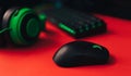 Computer gaming mouse and keyboard and green hedset on red background Royalty Free Stock Photo