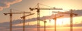 Construction cranes at sunset Royalty Free Stock Photo