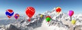 Hot air balloons over snow covered mountains