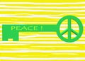 A bright green colored key with a peace symbol ring for key chain hooking against a light yellow striped backdrop