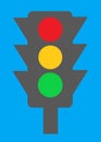 A dark grey silhouette of a traffic light showing red amber green lighting turquoise blue backdrop