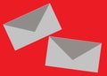 A pair of grey envelopes showing the back cover sleeve bright red backdrop Royalty Free Stock Photo