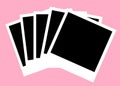 A stack and spread of some black blank polaroid photos from instant film cameras pink backdrop Royalty Free Stock Photo