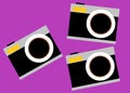 Three identical nostalgic black vintage film camera with build in flash magenta violet backdrop