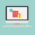 Computer with gift shopping bag icon on screen. Royalty Free Stock Photo