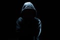 Computer hacker in black mask and hoodie. Obscured dark face. Data thief, internet fraud, cyber security concept Royalty Free Stock Photo
