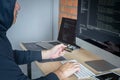 Computer hacker or cyber attack concept, Dangerous hooded hacker using multiple computers typing bad data into online system the Royalty Free Stock Photo