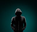 Computer hacker in hoodie. Obscured dark face. Data thief, internet fraud, darknet and cyber security concept.