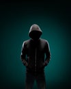 Computer hacker in hoodie. Obscured dark face. Data thief, internet fraud, darknet and cyber security concept.