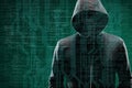 Computer hacker in mask and hoodie over abstract binary background. Obscured dark face. Data thief, internet fraud Royalty Free Stock Photo
