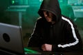 Computer hacker typing code on keyboard late night working and bypassing cyber security. Royalty Free Stock Photo