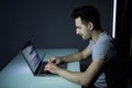 Computer hacker working in dark room programing at night Royalty Free Stock Photo