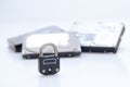 Computer hard disks and metal padlock concept for encrypted data, cyber security on white background Royalty Free Stock Photo