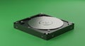 A computer hard drive is placed on a vibrant green surface. The drive has a sleek Royalty Free Stock Photo