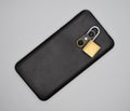 Mobile with open padlock around the photo camera. Royalty Free Stock Photo
