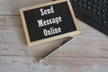 computer keyboard and blackboard on wooden background. Send message online. Royalty Free Stock Photo
