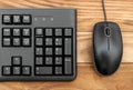 Computer keyboard with computer mouse on wooden table. Top view Royalty Free Stock Photo