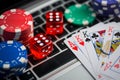 Computer Keyboard Covered With Playing Cards, fiches and Dice Royalty Free Stock Photo