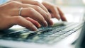 Computer keyboard and female fingers typing on it in a close up