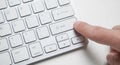 Computer keyboard with finger pressing button Royalty Free Stock Photo