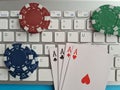 Computer keyboard four aces and cards casino chips and dice closeup Royalty Free Stock Photo