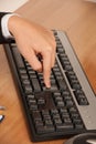 Computer keyboard and hand pressing the enter key Royalty Free Stock Photo