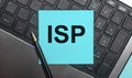 The computer keyboard has a pen and a blue sticker with the text ISP Internet Service Provider. Flat lay Royalty Free Stock Photo