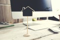 Computer keyboard and house model on working desk Royalty Free Stock Photo