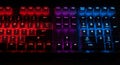 A computer keyboard is illuminated with RGB backlighting. Keys on the left are lit in red Royalty Free Stock Photo