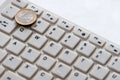 Computer keyboard and one euro coin close up on a white background. Internet business. Currency exchange Royalty Free Stock Photo