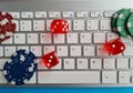 Computer keyboard playing dice and casino chips Royalty Free Stock Photo