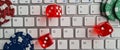 Computer keyboard playing dice and casino chips Royalty Free Stock Photo