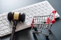 Computer keyboard , shopping cart and auction hammer on black