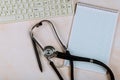 Computer keyboard on stethoscope over notebook the medical table at the doctor Royalty Free Stock Photo