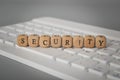 Computer keyboard and wooden cube with text SECURITY Royalty Free Stock Photo
