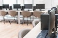 Computer lab blur background with pc desktop computer machine in blurry empty school class room or office desk interior workspace Royalty Free Stock Photo