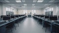 A computer lab filled with rows of computers under fluorescent lighting Royalty Free Stock Photo