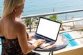 Computer laptop with blank screen near the swimming pool. Royalty Free Stock Photo