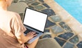 Computer laptop with blank screen near the swimming pool. Royalty Free Stock Photo