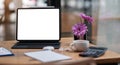 Computer Laptop with blank screen on table of coffee shop blur background with bokeh, desk blank work office mockup monitor Royalty Free Stock Photo