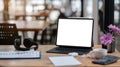 Computer Laptop with blank screen on table of coffee shop blur background with bokeh, desk blank work office mockup monitor Royalty Free Stock Photo