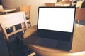 Computer laptop with blank white desktop screen on wooden table in cafe Royalty Free Stock Photo