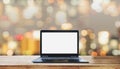 Computer laptop blank white screen on wooden desk, with blurry Bokeh light background Royalty Free Stock Photo